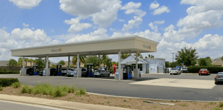 Walmart gas station with cars refueling.
