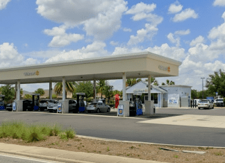 Walmart gas station with cars refueling.
